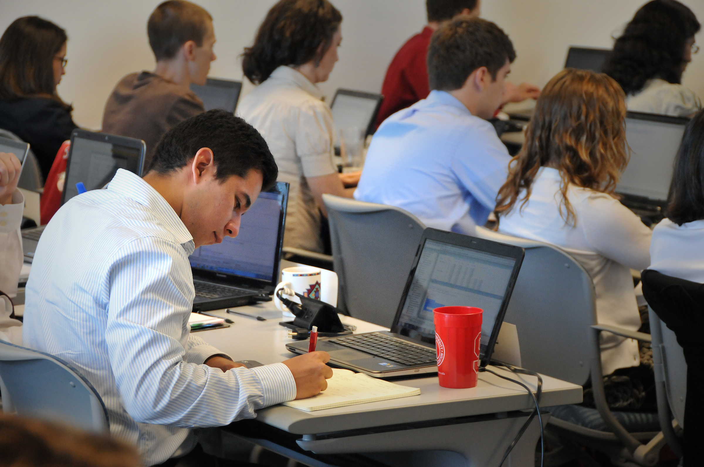 Institiute for Advanced Analytics student takes notes during class on Centennial Campus.