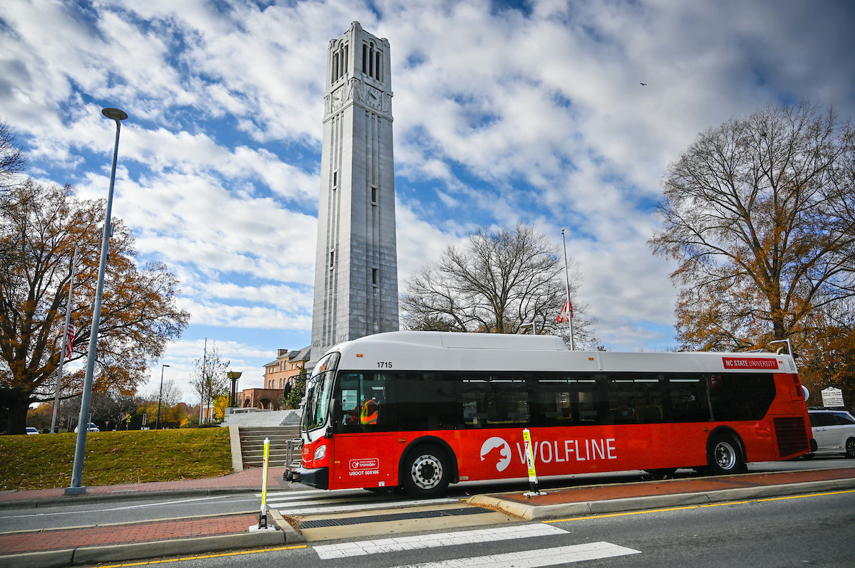 A Wolfline bus makes its way past the Belltower on Hillsborough Street. Photo by Marc Hall